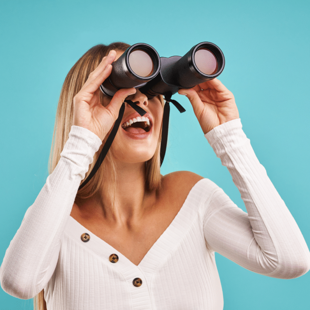 Irish business owner searching for Online Business Manager support through binoculars